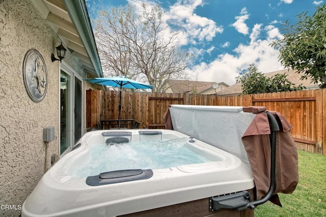 view of yard featuring a hot tub and fence