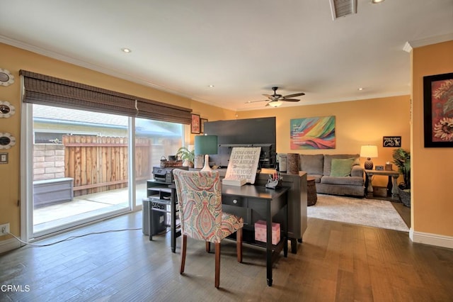 dining area featuring wood finished floors, baseboards, visible vents, ceiling fan, and ornamental molding