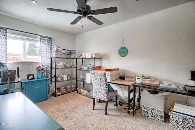 carpeted office featuring ceiling fan