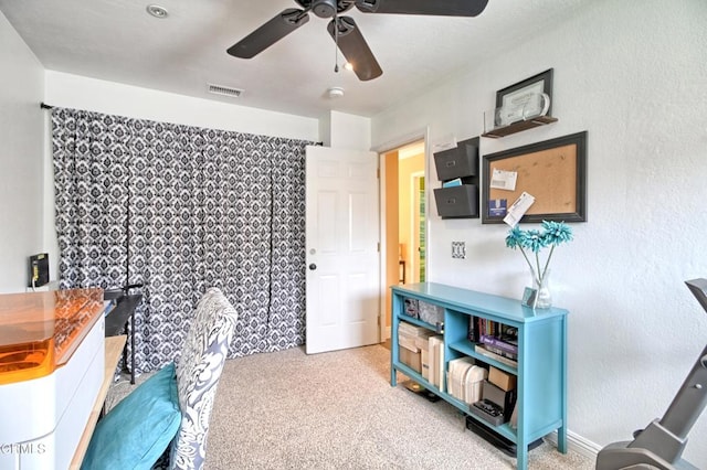 office with light colored carpet, visible vents, and ceiling fan