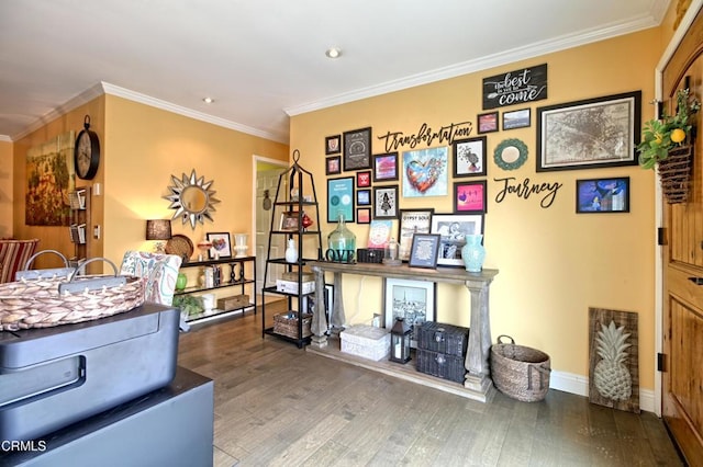 office area with baseboards, wood finished floors, and ornamental molding