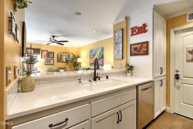 kitchen with a ceiling fan, a sink, light stone counters, stainless steel dishwasher, and crown molding