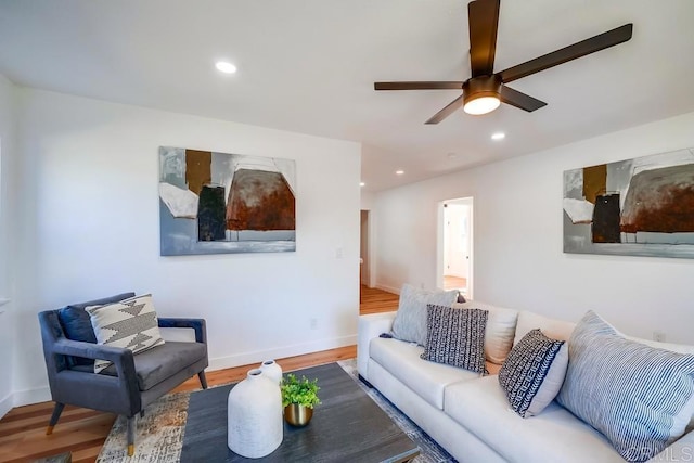 living room featuring a ceiling fan, recessed lighting, wood finished floors, and baseboards