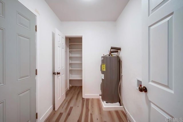 utility room featuring electric water heater