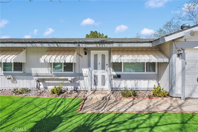 exterior space with an attached garage and a yard