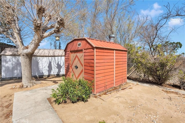 view of shed with fence