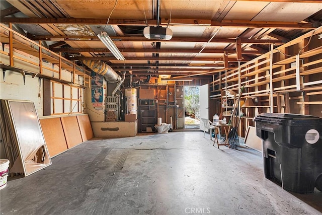 garage with gas water heater and a garage door opener