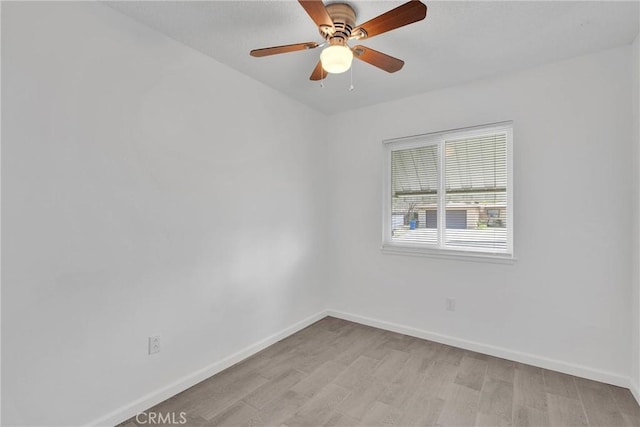 empty room with light wood-style flooring, baseboards, and ceiling fan