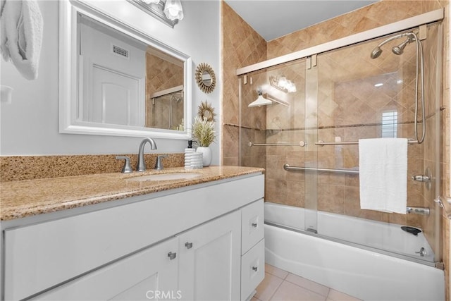 bathroom with tile patterned flooring, visible vents, vanity, and enclosed tub / shower combo