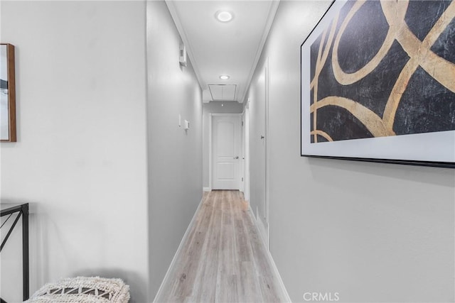 hallway with attic access, wood finished floors, and baseboards