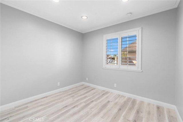 spare room with recessed lighting, crown molding, baseboards, and wood finished floors