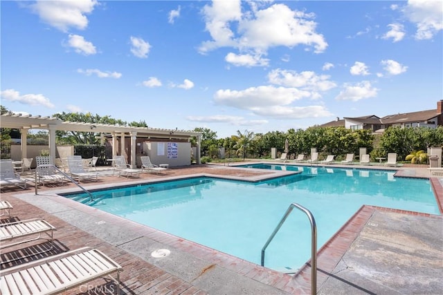 community pool featuring a pergola, a patio, and fence