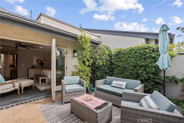 view of patio with an outdoor living space and ceiling fan