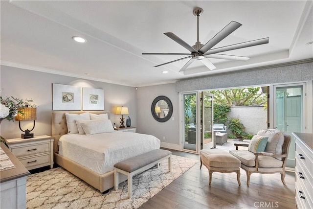 bedroom with baseboards, light wood-style flooring, recessed lighting, ornamental molding, and access to exterior