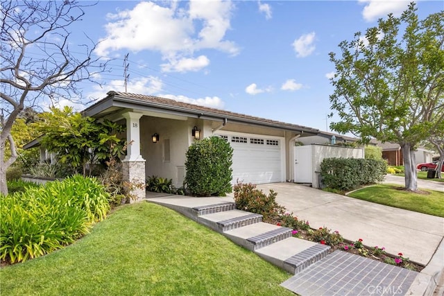 view of front of home with concrete driveway, an attached garage, a front lawn, and stucco siding