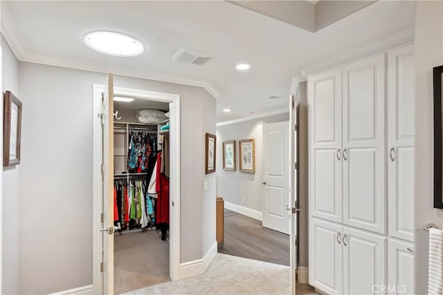 corridor with recessed lighting, visible vents, baseboards, and crown molding