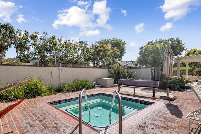 view of pool with an in ground hot tub, a fenced backyard, and a patio