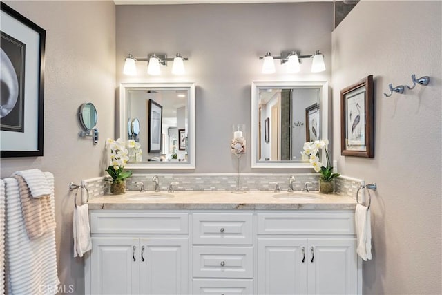 full bathroom featuring a sink, backsplash, and double vanity