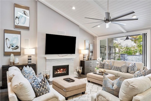 living room featuring high vaulted ceiling, recessed lighting, ceiling fan, a glass covered fireplace, and beamed ceiling