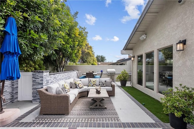 view of patio featuring an outdoor kitchen, an outdoor living space, a grill, and fence