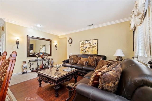 living room featuring visible vents, baseboards, and ornamental molding