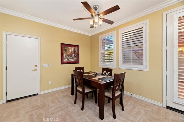 dining room with crown molding, baseboards, and ceiling fan