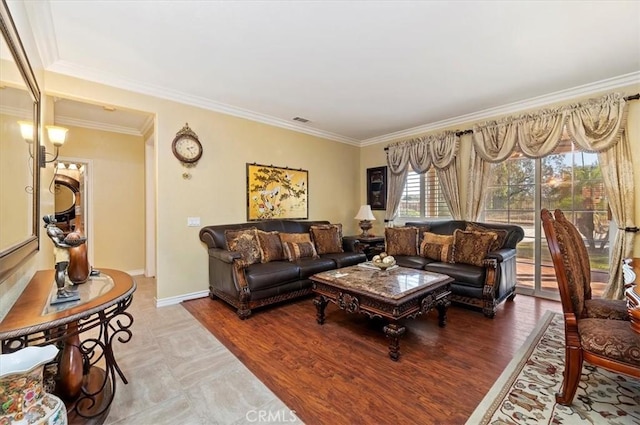 living room featuring wood finished floors, visible vents, baseboards, and ornamental molding