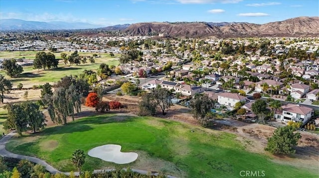 birds eye view of property with a mountain view and golf course view