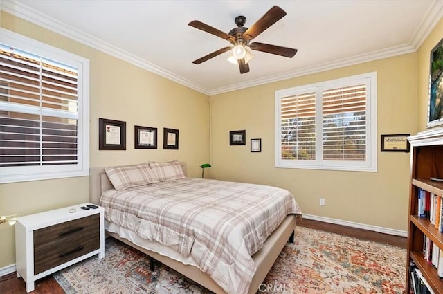 bedroom with wood finished floors, baseboards, and ornamental molding