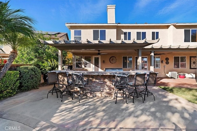 view of patio / terrace with ceiling fan, central AC, and outdoor dry bar