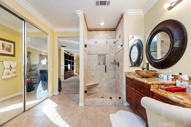 bathroom with tile patterned flooring, visible vents, a shower stall, and ornamental molding