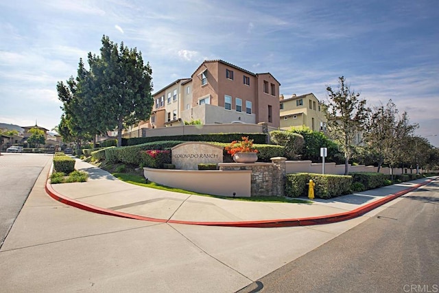 view of street with curbs, sidewalks, and a residential view