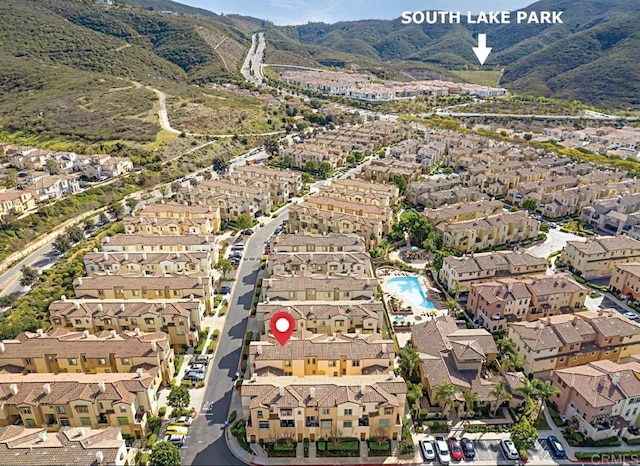 birds eye view of property with a mountain view and a residential view