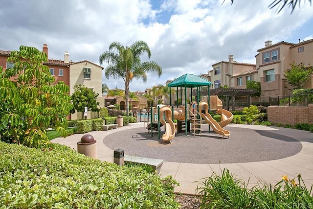 community jungle gym with fence and a residential view