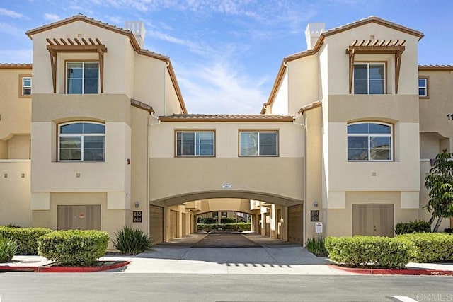 view of front of property with a tiled roof and stucco siding