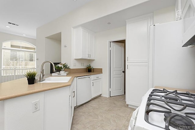 kitchen featuring visible vents, light countertops, white appliances, white cabinetry, and a sink