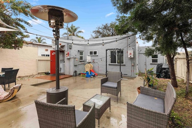 view of patio with outdoor lounge area and fence