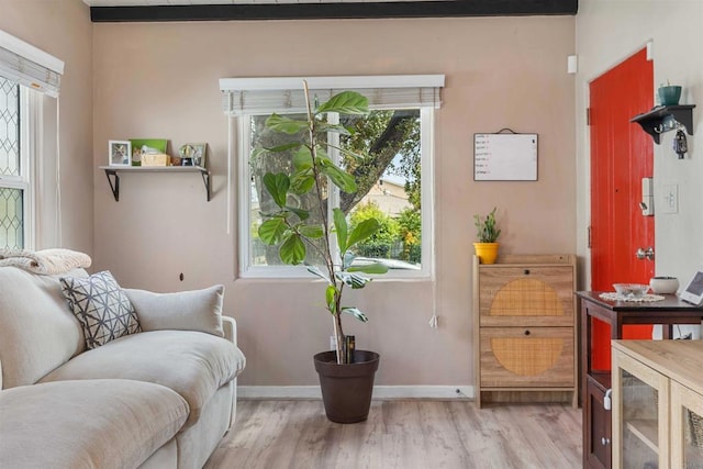 sitting room with light wood-type flooring and baseboards