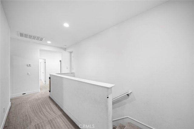 hallway featuring visible vents, an upstairs landing, light carpet, recessed lighting, and baseboards