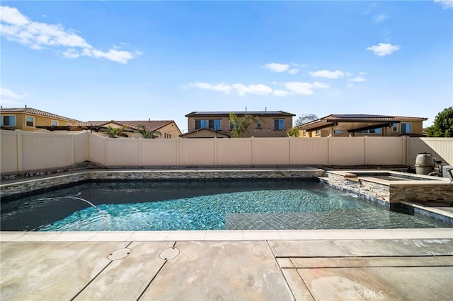 view of pool with a patio, a fenced backyard, and a pool with connected hot tub