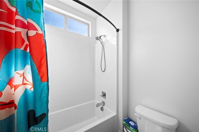 full bath with toilet and shower / tub combo with curtain