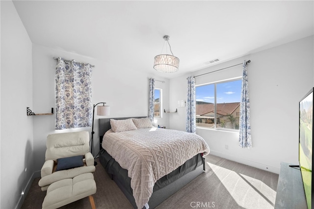 bedroom with visible vents, baseboards, and carpet