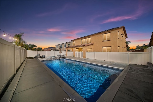 view of swimming pool with a patio area, a pool with connected hot tub, and a fenced backyard