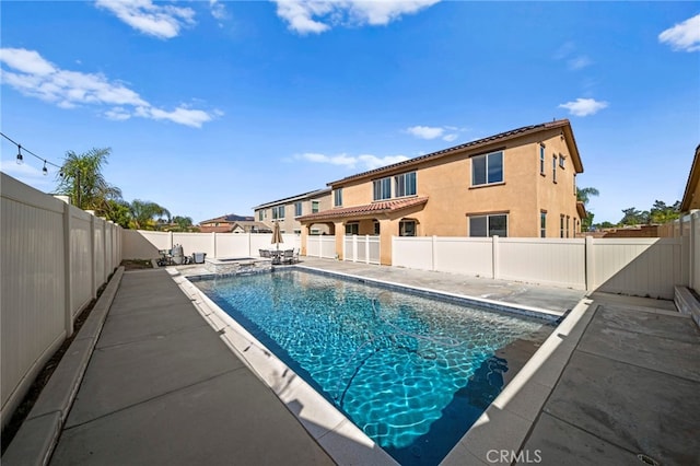 view of pool with a patio, a fenced backyard, and a pool with connected hot tub