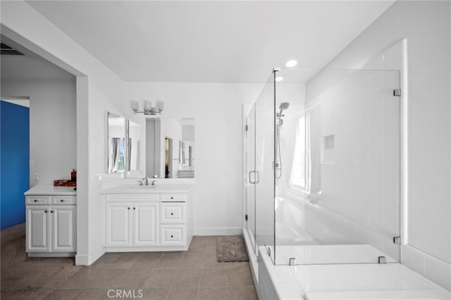 full bathroom featuring tile patterned flooring, a shower stall, vanity, and baseboards