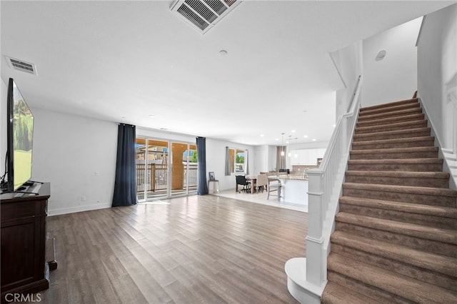 interior space with recessed lighting, wood finished floors, visible vents, and baseboards