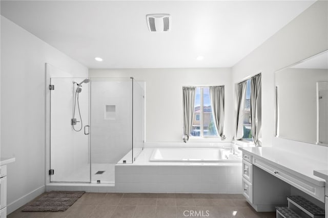 full bath with vanity, a shower stall, a garden tub, and tile patterned flooring