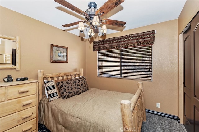 bedroom featuring a closet, a ceiling fan, carpet, and a textured wall