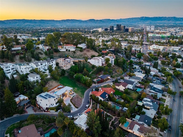 aerial view at dusk featuring a mountain view