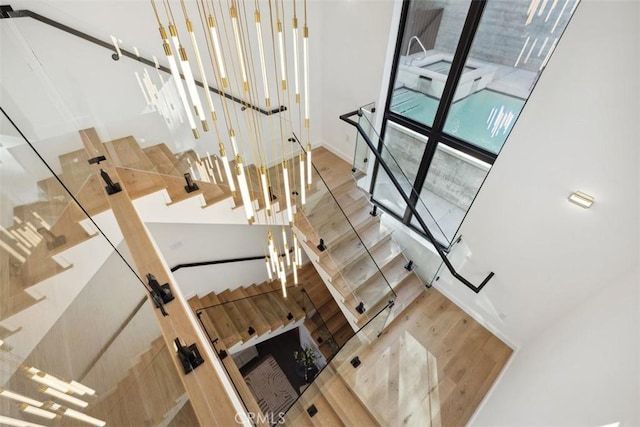 staircase with wood finished floors and baseboards